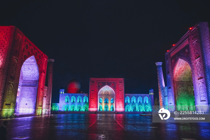 Registan square in Samarkand lit in colourful lights, Uzbekistan