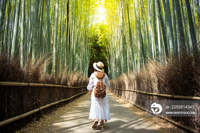 Touist is walking inside bamboo forest Arashiyama, Kyoto, Japan.