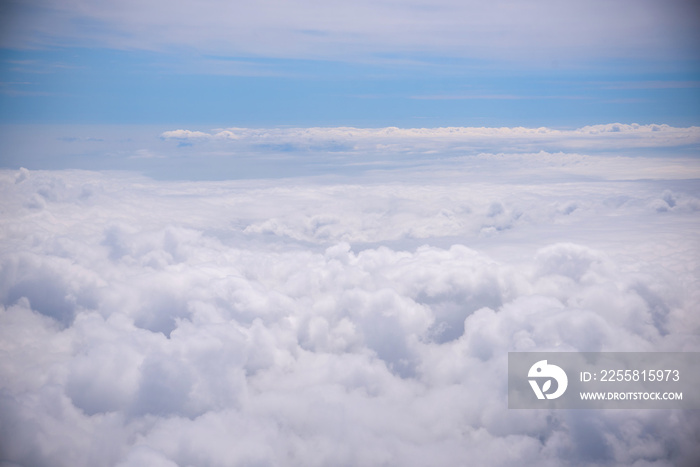 White fluffy clouds in the blue sky. Photos of clouds from the passenger liner porthole. Photo background