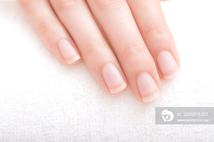 Beautiful natural fingernails and fingers of young woman after manicure