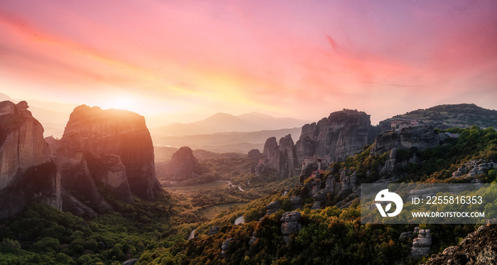 Fantastic Landscape with monasteries and rock formations in Meteora during sunset, Greece. Mysterious Sunny Morning with colorful sky. Awesome Nature Landscape. Popular travel locations.