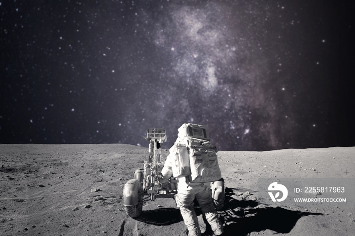 Astronaut on rock surface with space background. Elements of this image furnished by NASA