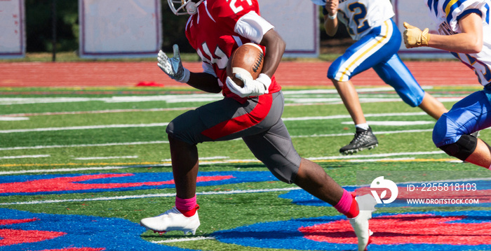 Football running back being chased by defensive players down the field