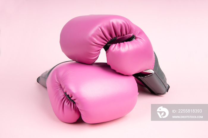 Pair of pink boxing gloves on pink background