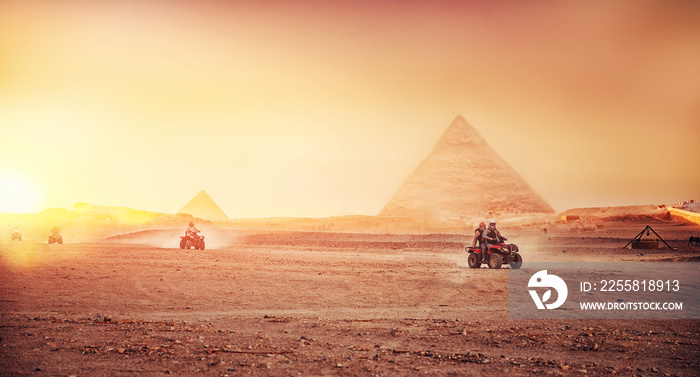 Quad bikes ATV safari in desert background Pyramids Sphinx Cairo, Egypt