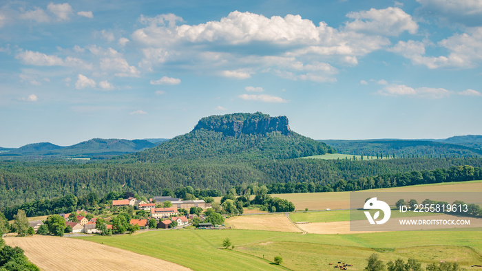 Panoramic view over monumental Lilienstein sandstone pillars, an iconic table like mount at sunset in the national park Saxon Switzerland by Dresden and Czechish border, Saxony, Germany.