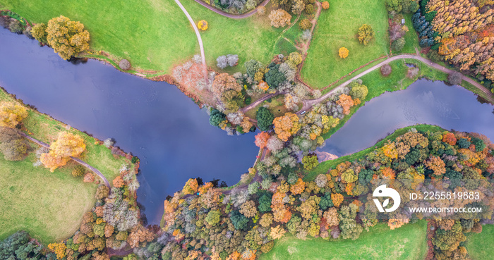 Top down view over Park, Pond and Gardens from a drone in the colors of fall, Exeter, Devon, England, Europe