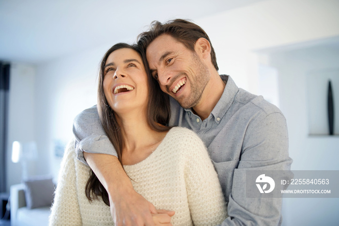 Portrait of handsome couple in modern house