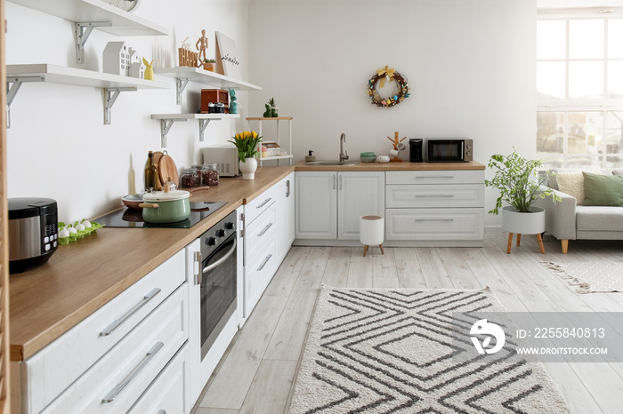 Interior of kitchen with Easter wreath and white counters