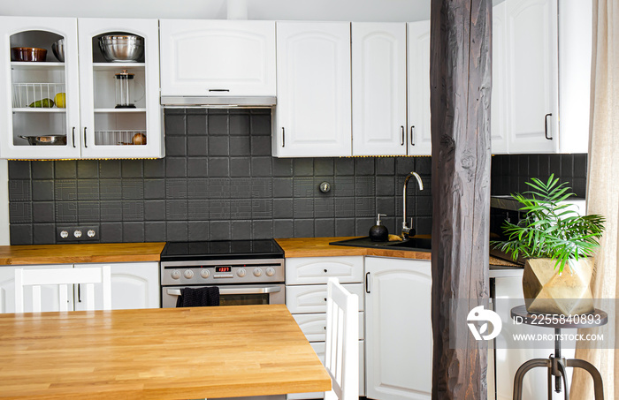 Modern white color home kitchen corner with solid natural color oak wood countertop and  various app