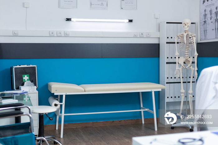 Examination bed standing in empty medical doctor office ready for patient consultation. Hospital wor