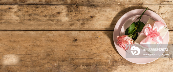 Romantic dinner table on rustic background. Love cutlery for Valentines or Mothers day, Wedding