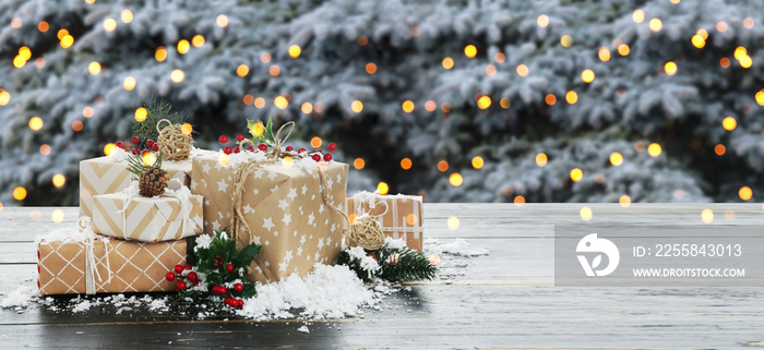 Beautiful Christmas gift boxes, snow and decor on table