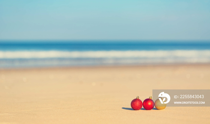 Christmas ornaments on a tropical beach