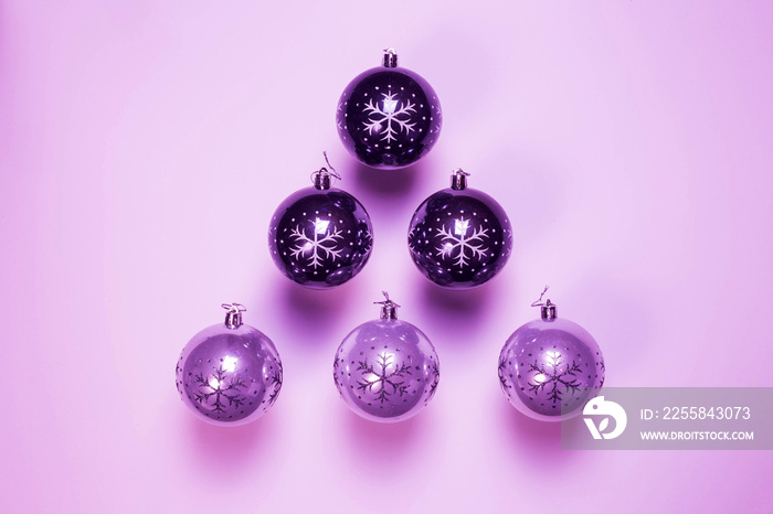Purple Christmas ornament, christmas balls in a row near purple background, retro design