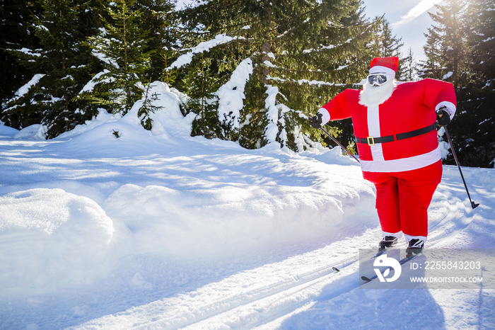 Santa Claus with Christmas suits with classic  nordic ski in snowy winter mountain ski resort landsc