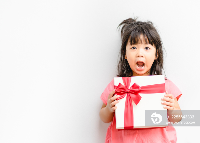 Little asian girl smile and excited and holding red gift box on white background.child holding gift 