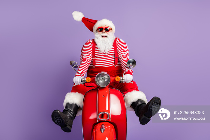 Photo of funky santa claus carefree drive scooter wear x-mas costume striped shirt cap eyewear isola