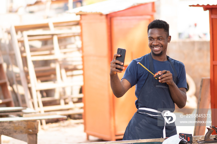 young african carpenter doing a video call with a client