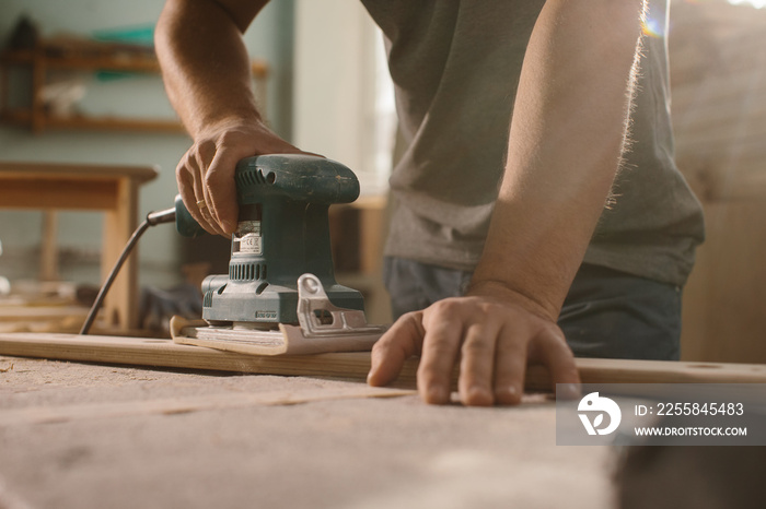 Grinding machine makes wooden polishing of bar plank.