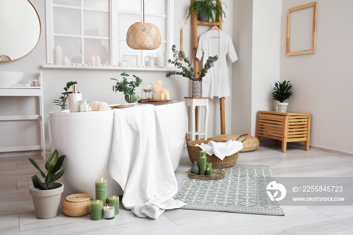 Interior of modern bathroom with burning candles