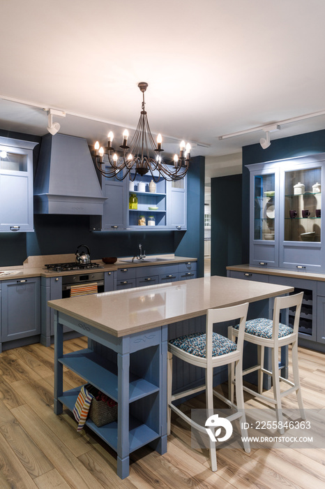 Interior of modern kitchen with chandelier over table