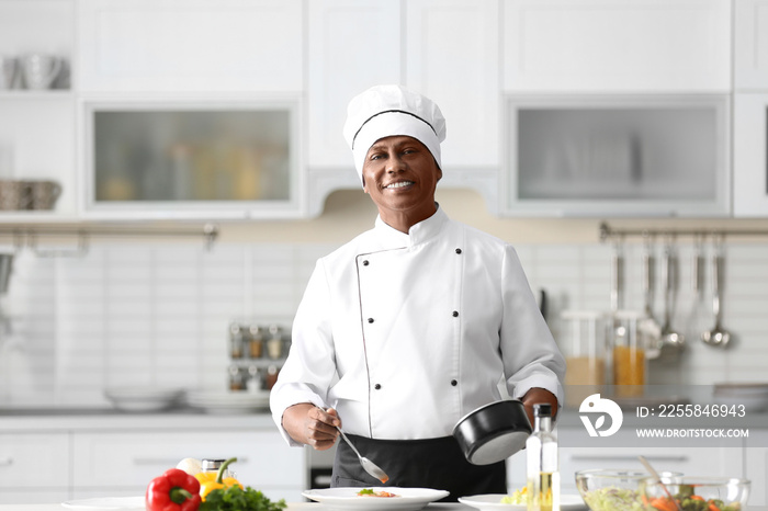 Mature Indian chef cooking in kitchen