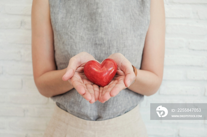 woman holding red heart, health insurance, donation charity concept, world health day, world mental 