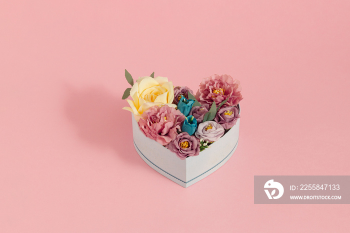 Creative love concept with colorful flowers in heart gift box. Blooming flowers like  a present on p