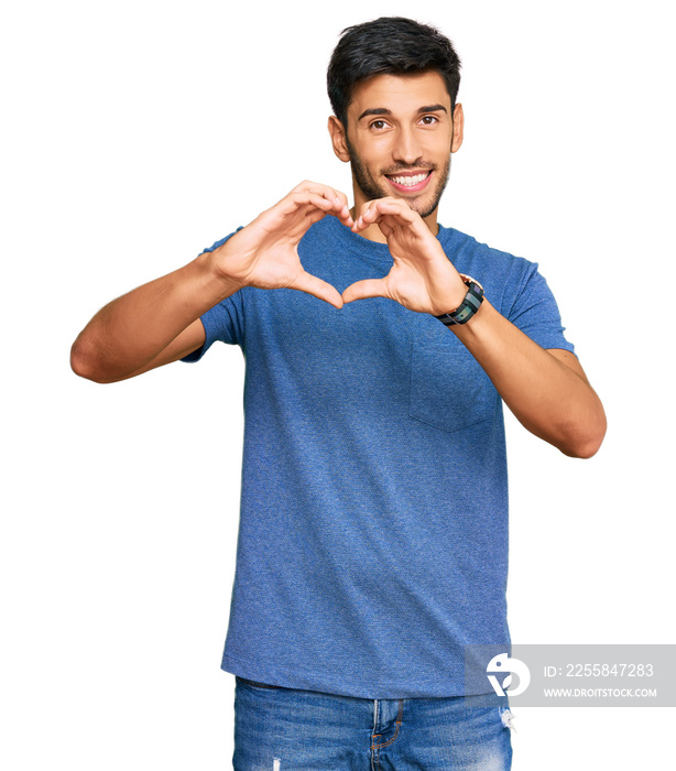 Young handsome man wearing casual clothes smiling in love showing heart symbol and shape with hands.