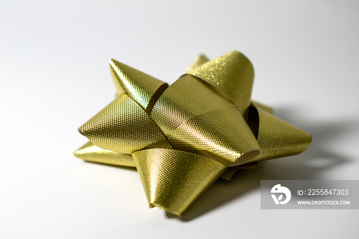 Matte gold bow isolated on white background side view