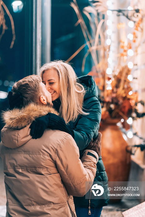 Outdoor close up portrait of young beautiful couple posing on street.