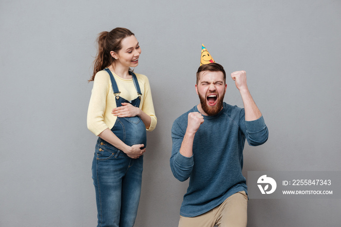 Portrait of a young excited family expecting child