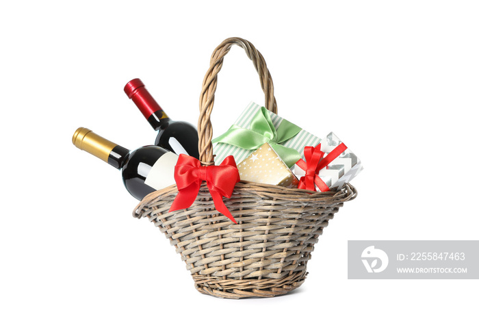 Wicker basket with bottles of wine and presents isolated on white background