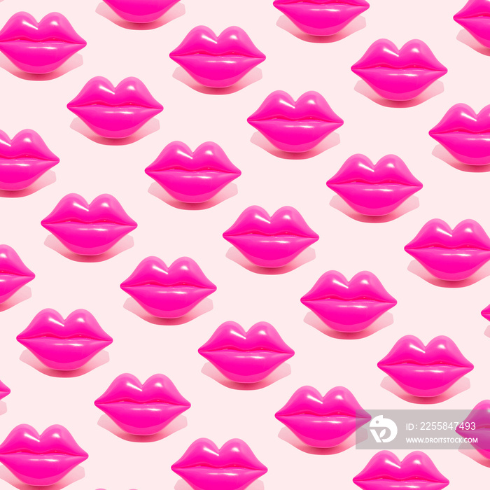 Creative pattern made with magenta lips figurine on pastel pink background. 80s or 90s romantic retr