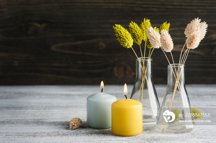 Lit candles and dry flowers