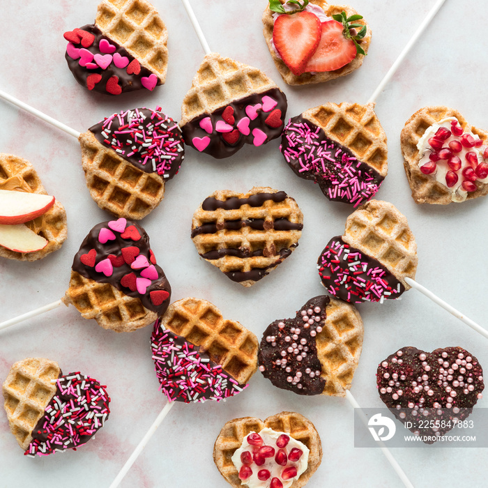 Top down view of decorated heart shaped waffle pops for Valentines Day.