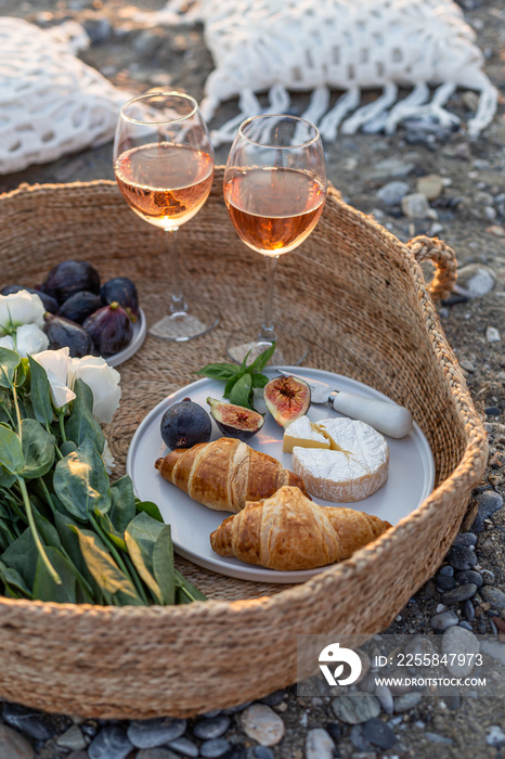 Summertime concept. Outdoor picnic with wine and croissants