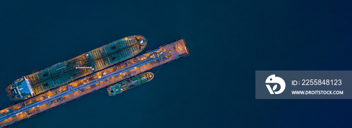 Aerial view tanker ship loading in port at night, Tanker ship logistic import export business and tr