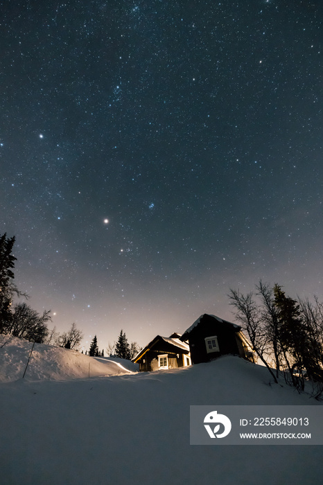 Christmas NIght Holiday with stars and Cabin House in Norway