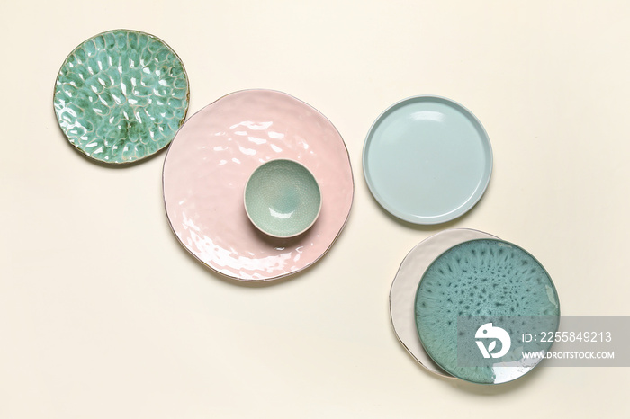 Set of stylish ceramic plates on light background