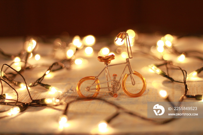 bicycle toy christmas lights on wooden planks.