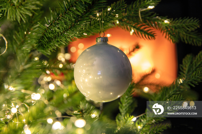 Christmas tree decoration bauble and lights close up, burning fireplace background