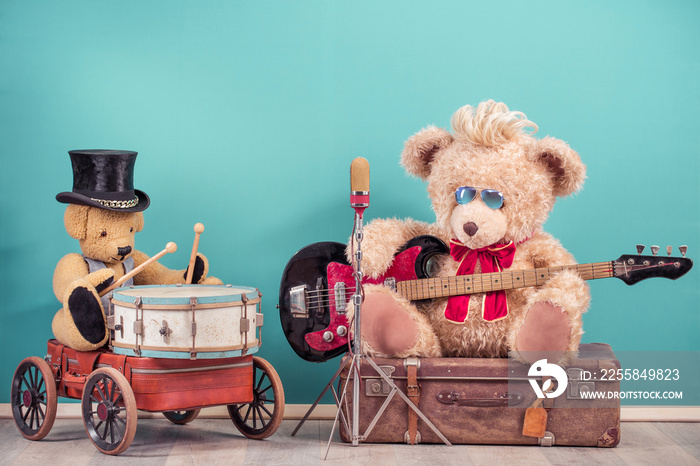 Retro Teddy Bear toys with play bass guitar and sitting on old luggage, golden microphone, bear in c