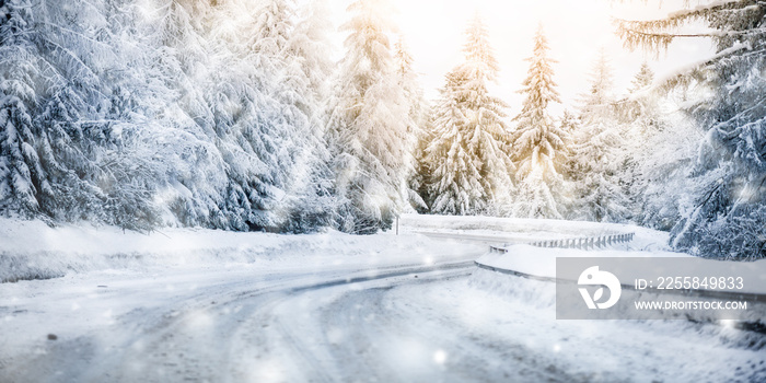 Winter beautiful snowy road snow or landscape forest and trees covered with snow. Yellow sun shine l