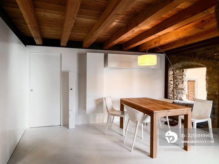 interior shots of a modern dining room with wooden table the ceiling made of wood and the floor made