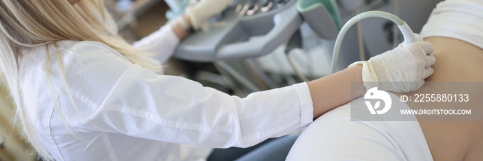 Woman doctor doing kidney ultrasound examination in clinic