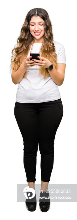 Young adult woman using smartphone with a happy face standing and smiling with a confident smile showing teeth