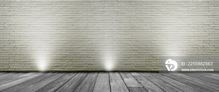 Empty space studio room with spotlight of white brick wall and wooden floor.