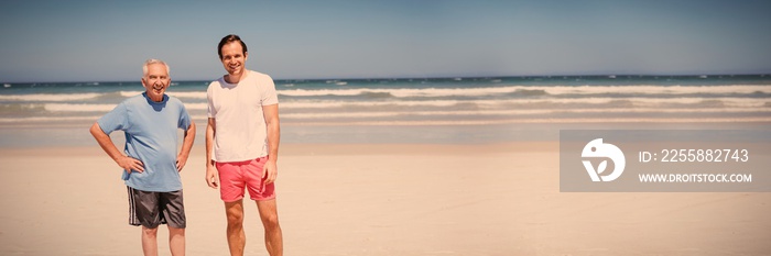 Portrait of man with father standing at beach